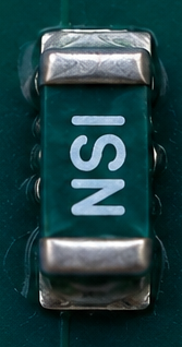 Close-up photograph of an NSI 1206 sensor mounted on FR4